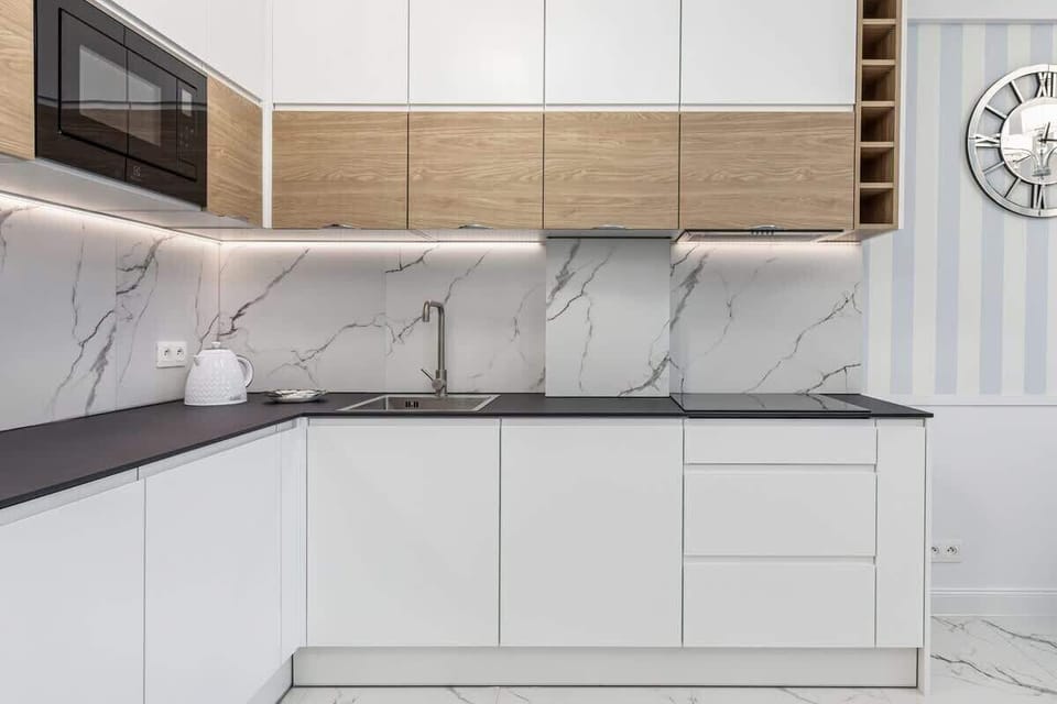 Kitchenette with kettle and refrigerator. 