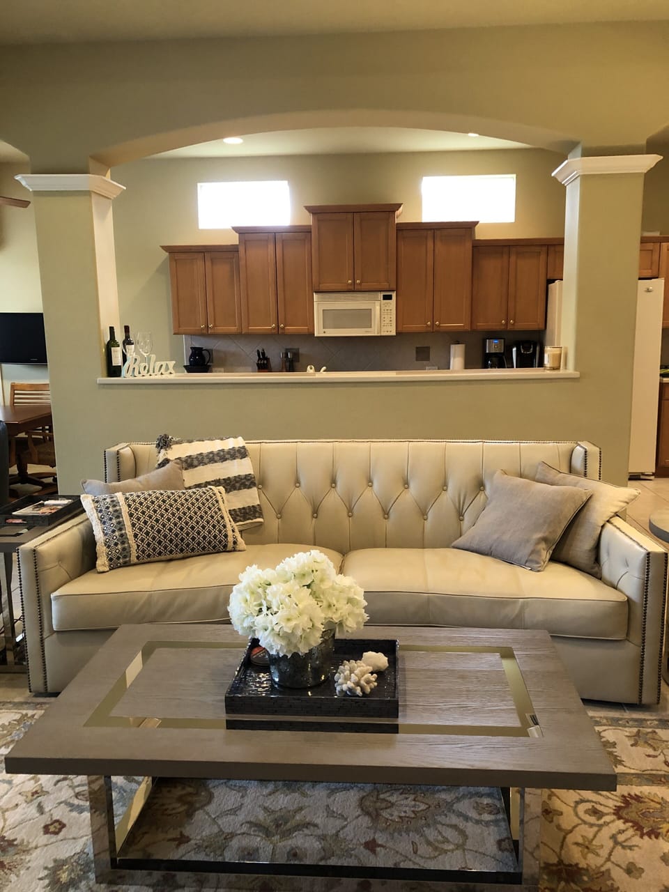 Elegant couch-inviting curve for that cozy feeling-multiple cushions & throws!