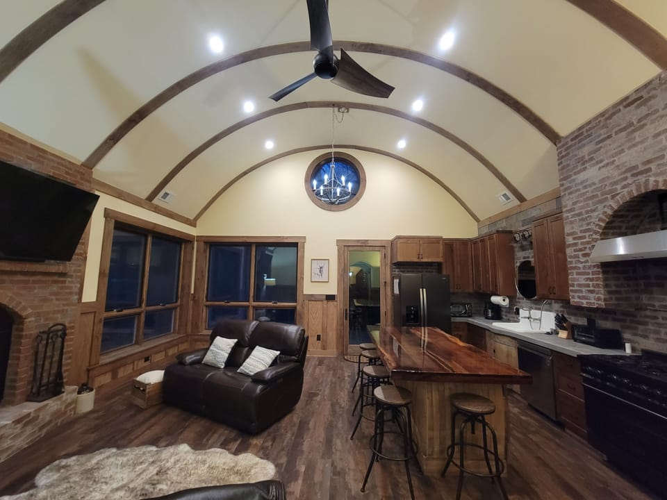 Great room - living on left, kitchen on right.  16ft round-vaulted ceilings