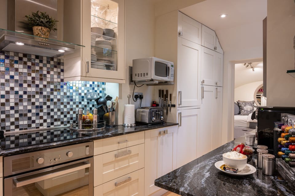 GALLEY KITCHEN with frig/freezer, dishwasher, oven/cooktop, microwave.
