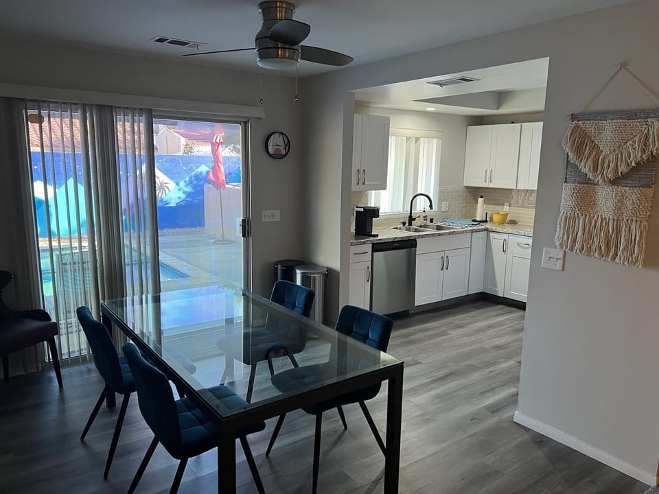 Dining and kitchen overlooking pool