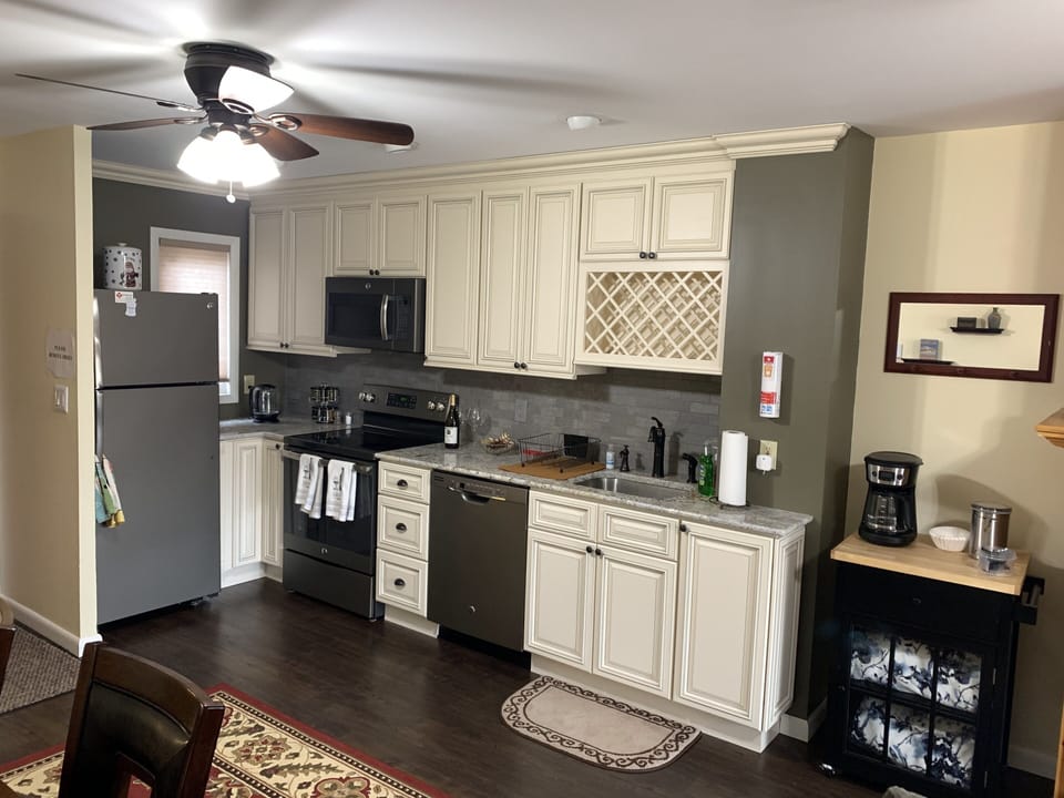 Stocked kitchen with dishes, silverware, pots and pans, utensils, coffee etc.