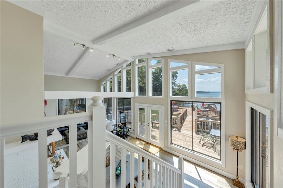 Wall of windows leads out to grills and 28 x 28 foot sun deck