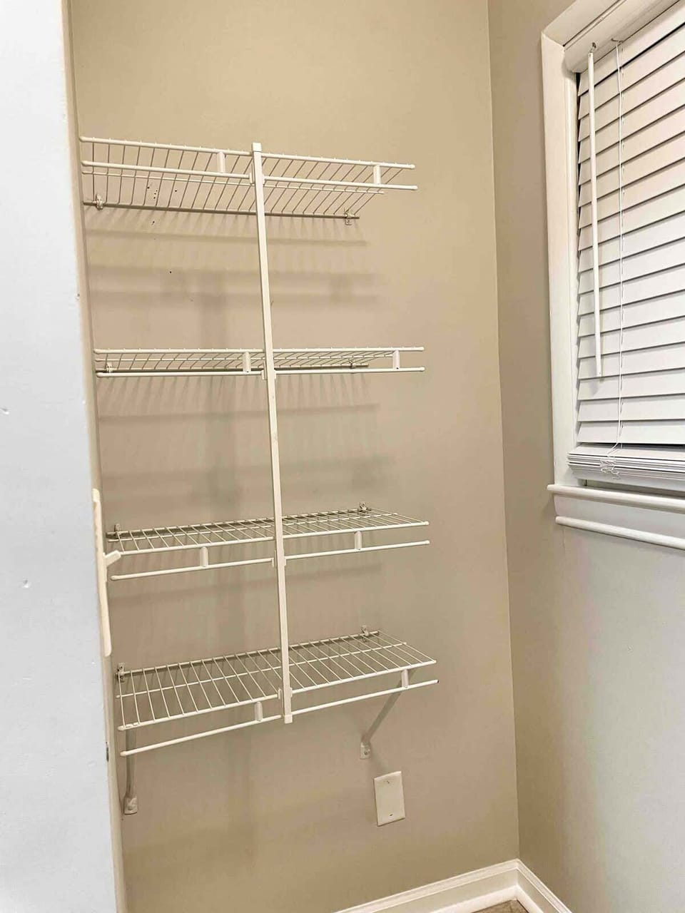 Primary bedroom closet with built-in shelving and storage space