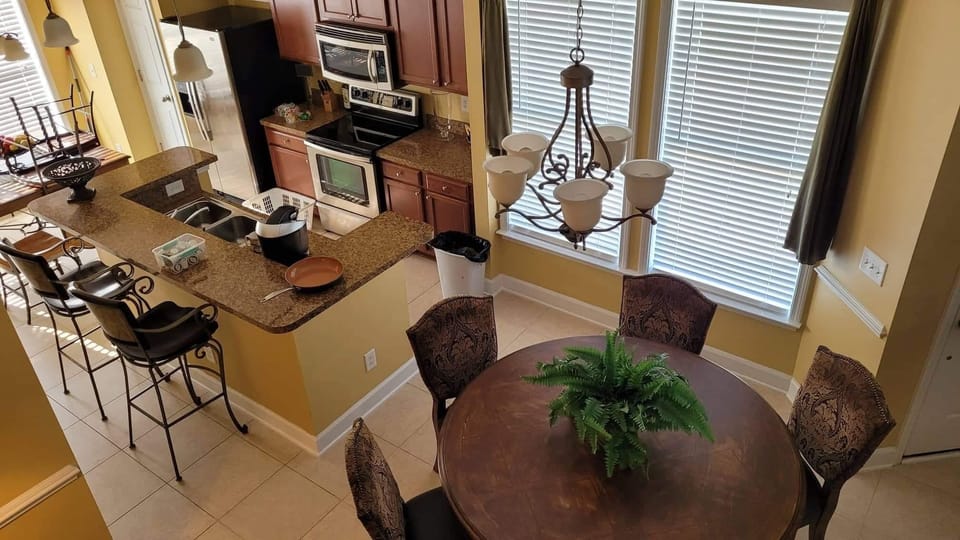 Kitchen and two dining areas. View from top of stairs