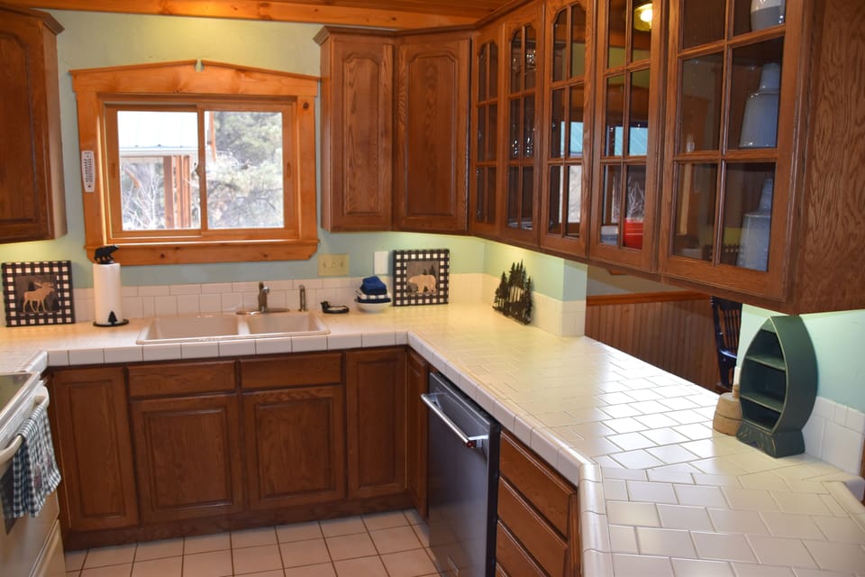 New dishwasher in fully stocked kitchen.