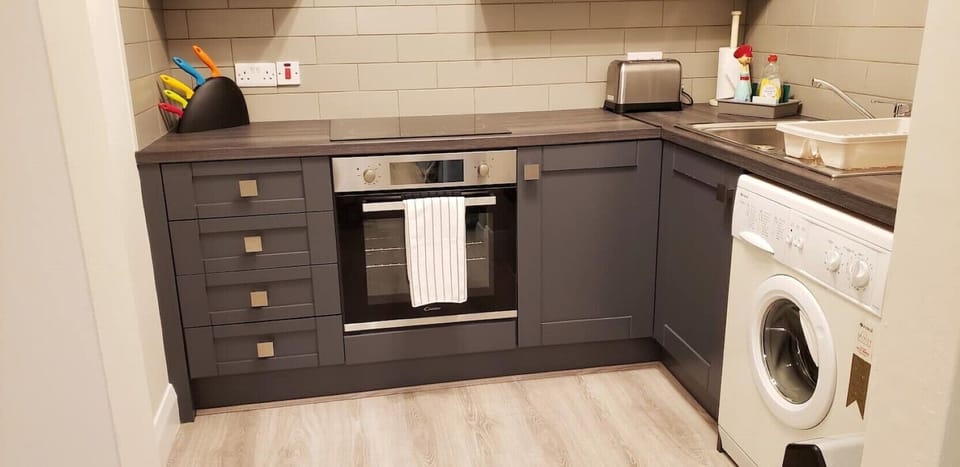 Kitchen showing stove and washer.