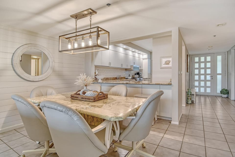 Bright dining area with elegant chandelier and cozy seating