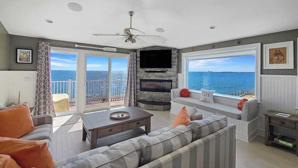 Wonderful living room with comfortable seating, slider to deck, TV and amazing views