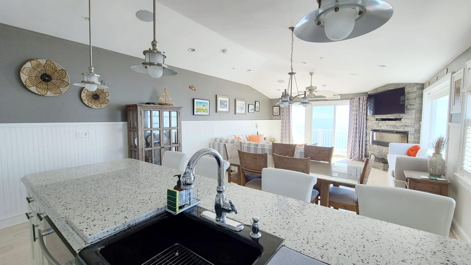 Kitchen opens to dining area and living room beyond