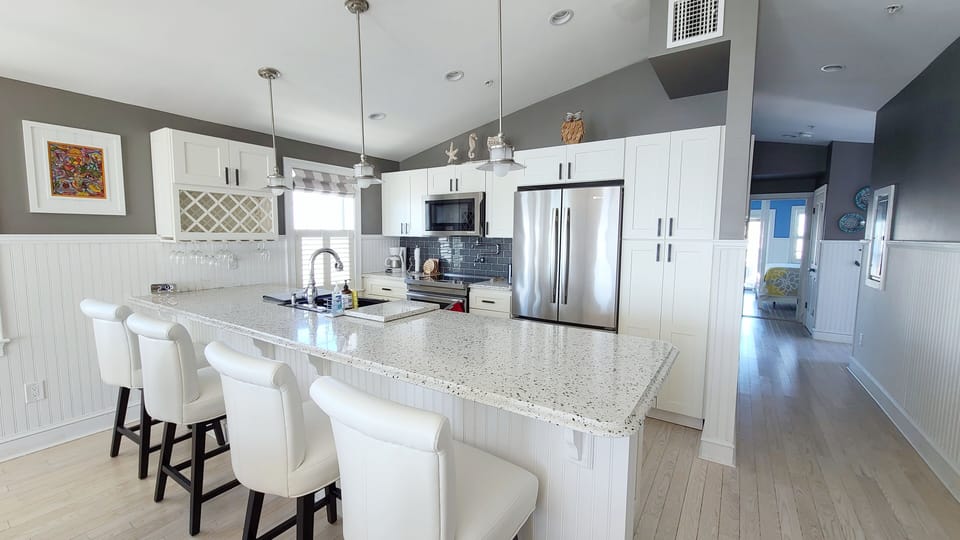Kitchen with counter seating and stainless appliances