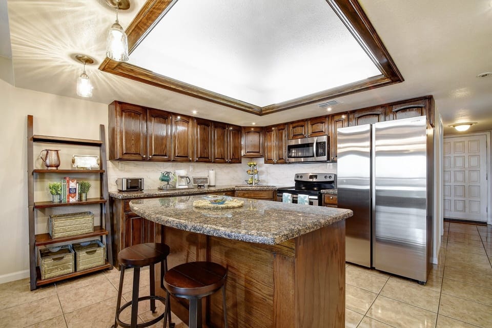 Bar stools at the kitchen island provide additional seating. 