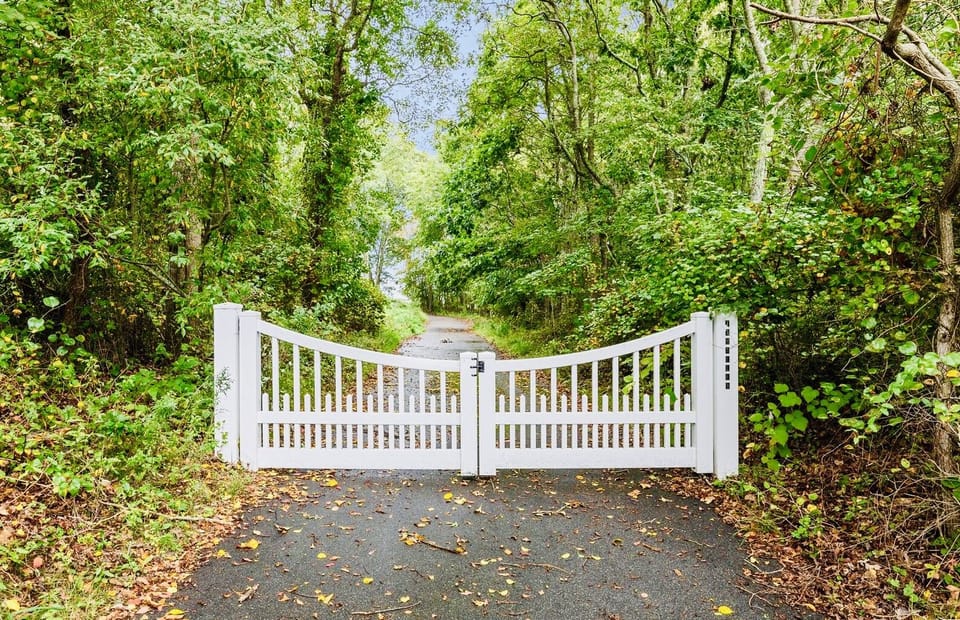 Thru the white-gated entrance is an impressive 1,200-foot-long private driveway.