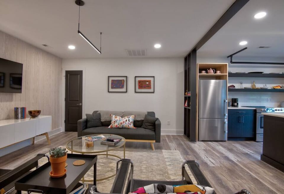 `Note the open flow from the living area to the spacious modern kitchen`, your host, Nancy