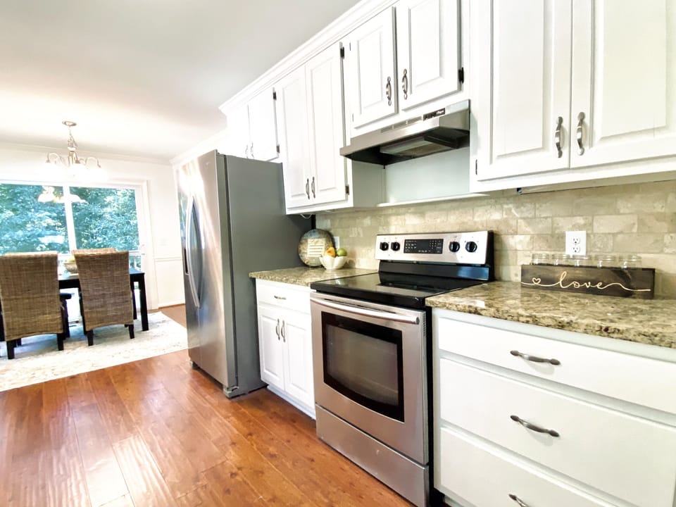 Fully stocked kitchen with stainless steel appliances.  