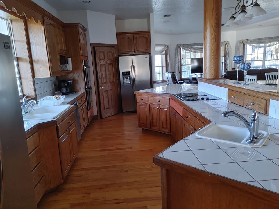 Full kitchen with two water and ice dispensing fridges, dishwasher, Keurig coff 