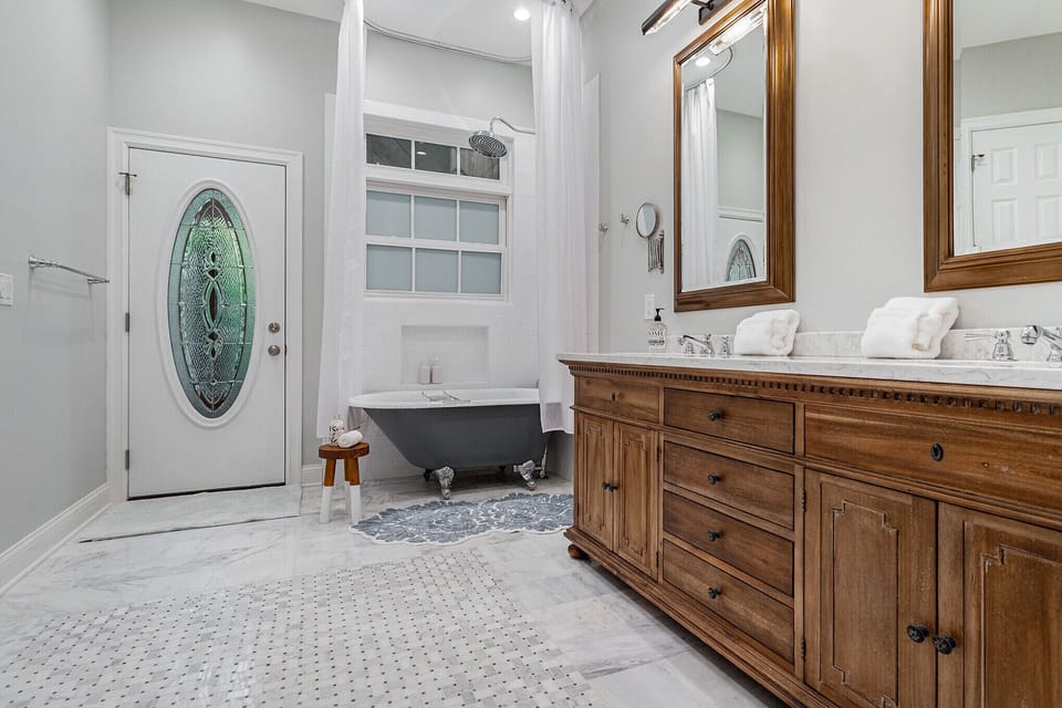 Master bath with claw foot tub and access to the hot tub