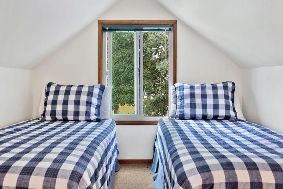 Peaceful cabin bedroom with plush bedding, and beautiful views—ideal for restful nights, cozy mornings, and a relaxing mountain escape.