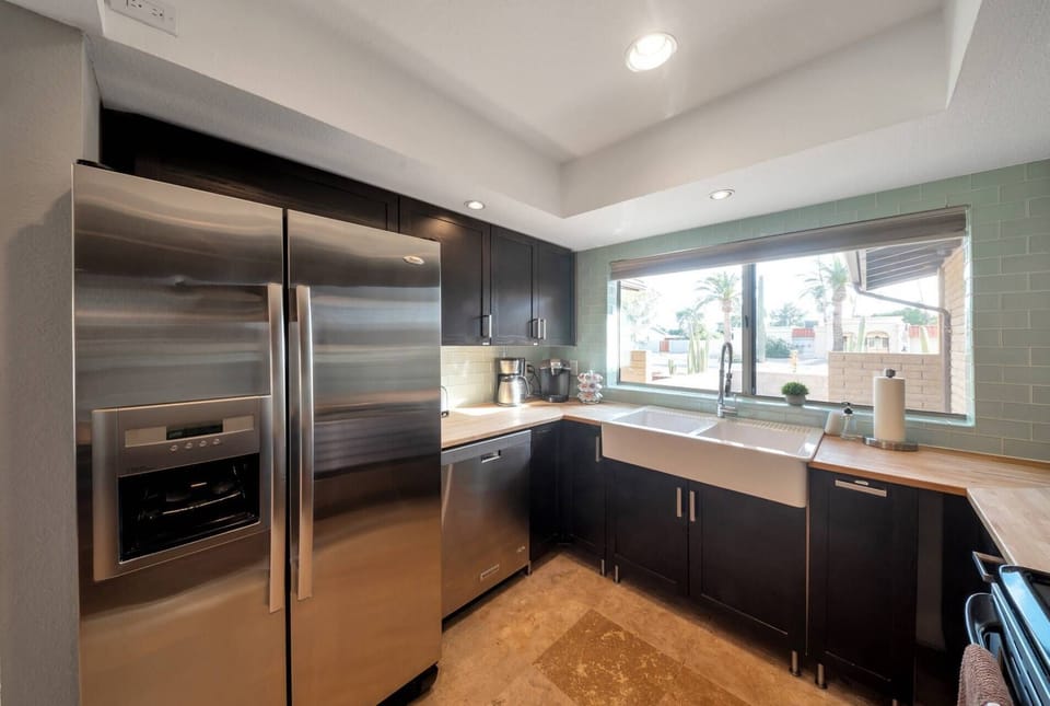 Kitchen features a traditional & Keurig coffee maker, oven/stove, dishwasher, refrigerator