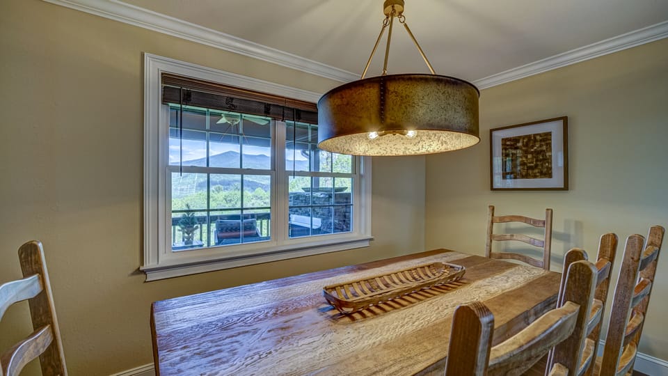 Main level dining room with a view.  Seats 8 on 5 chairs and a bench