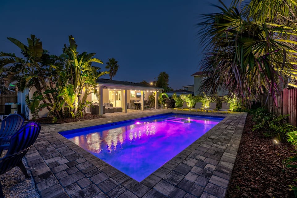 Backyard lit up at night for resort style vibes