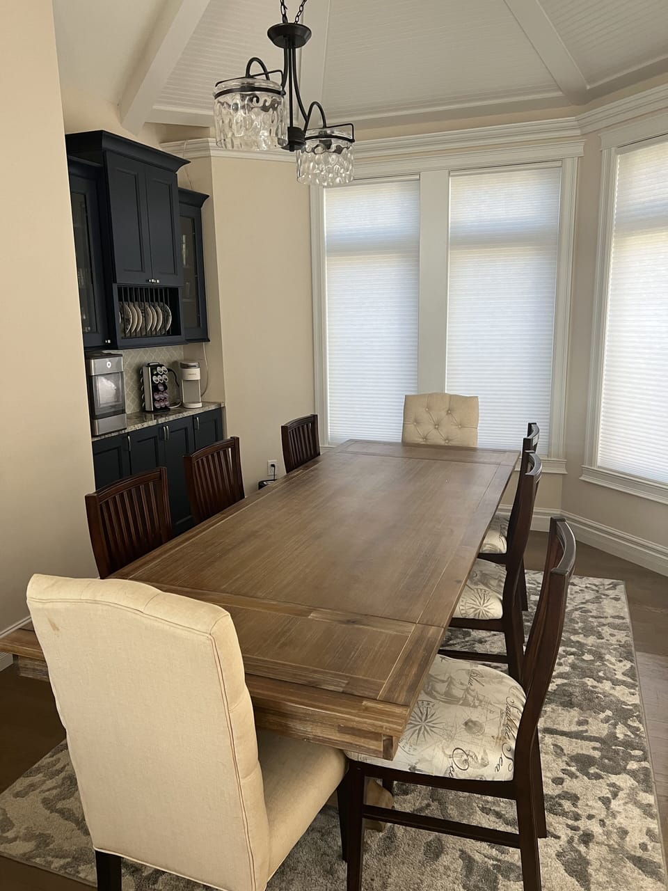 Large main level dining table.  Remote controlled window blinds