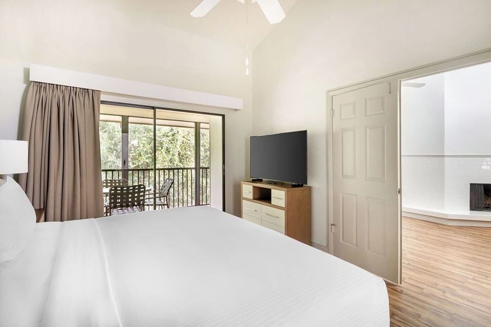 Wake up to balcony views and cozy in-room entertainment.