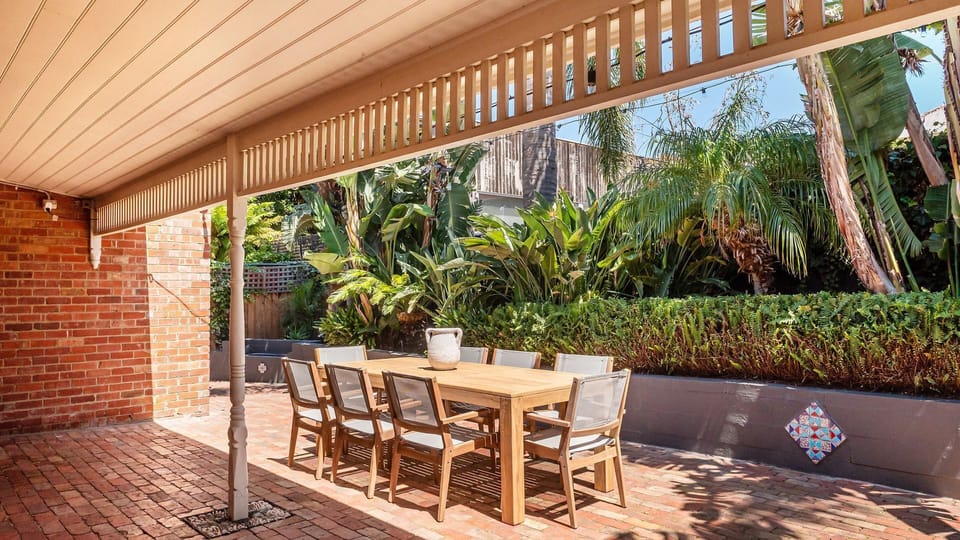 Outdoor courtyard with dining and festive lighting