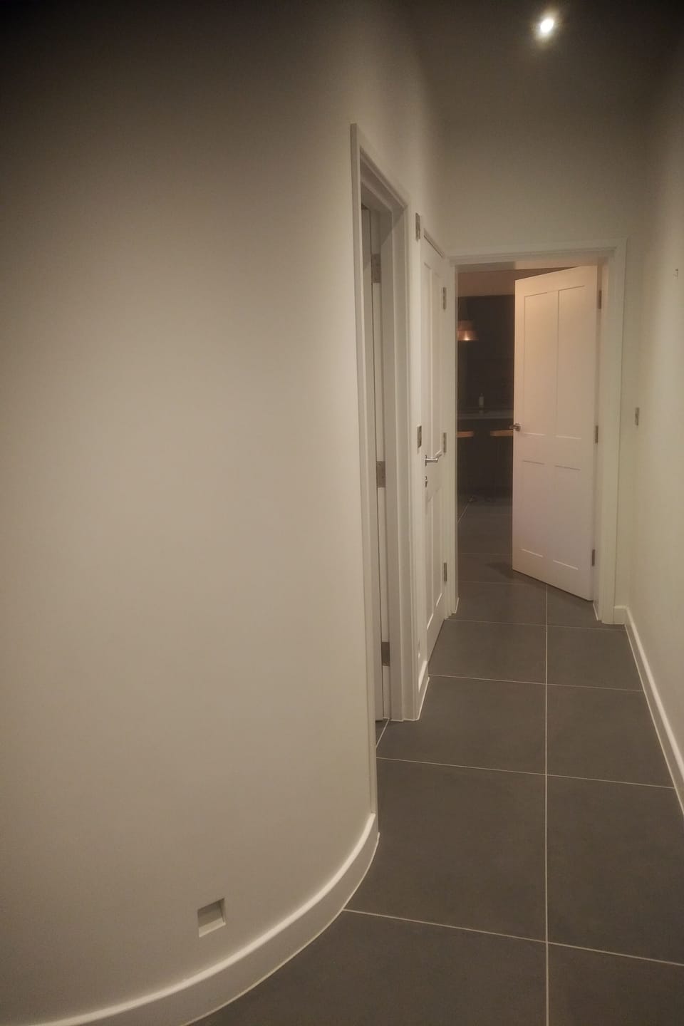 Hallway leading to utility room, cloakroom, kitchen and courtyard