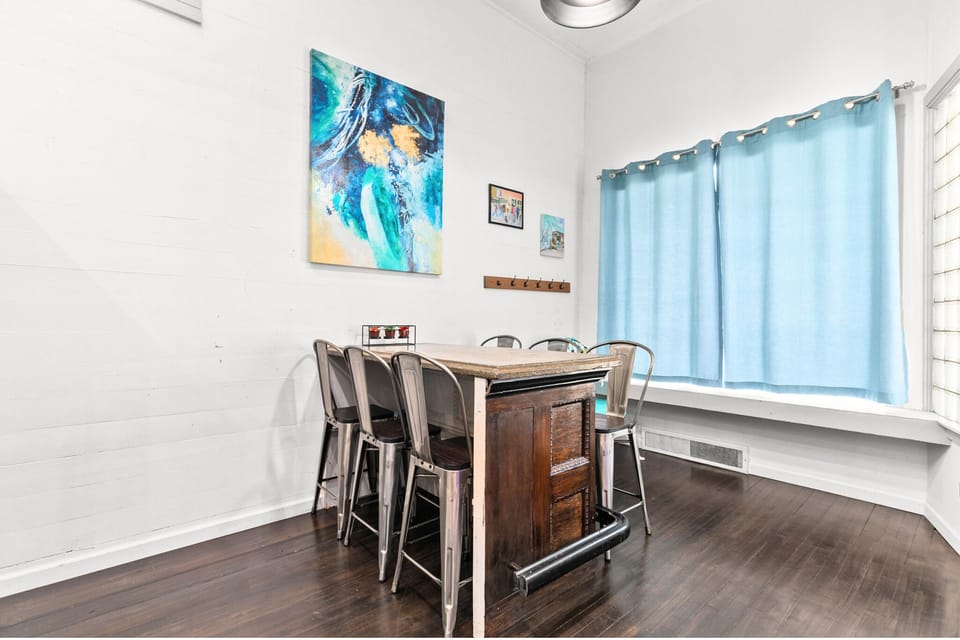 Hightop bar table with seating for 6. Custom made out of a historic door with a concrete bar top. Perfect spot for a round of cards.