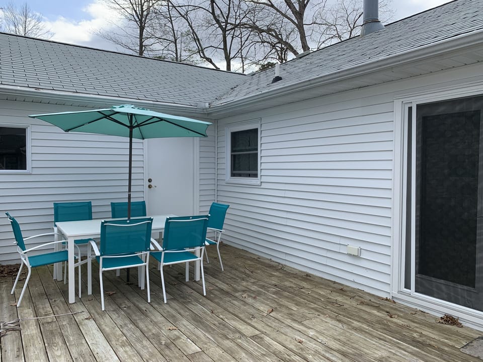 Back porch with full table and umbrella sets