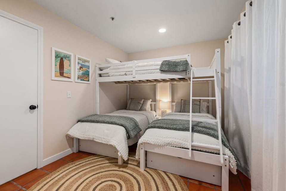 3rd bedroom with two twin beds and double bed above.