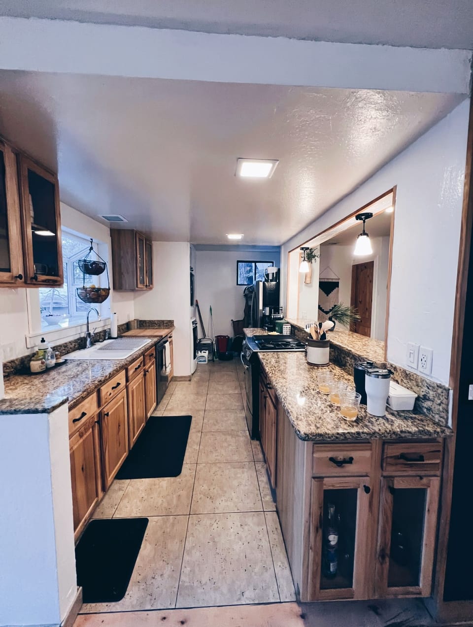 Galley kitchen. Fully stocked. Dishes, glasses, spices, coffee maker. 