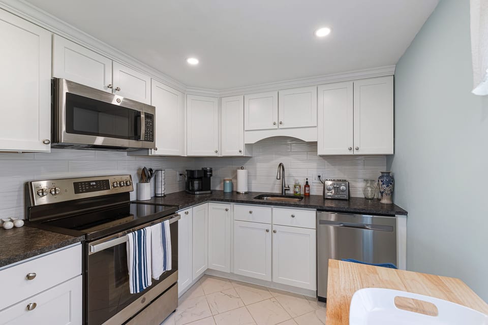 Fully equipped kitchen with modern appliances and Keurig coffee machine.