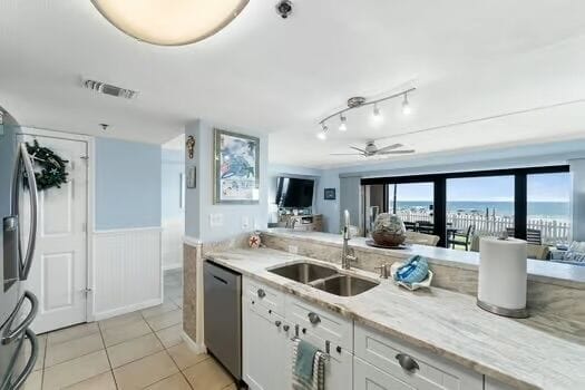 Kitchen with new countertops added in 2025 and view of patio with beach.