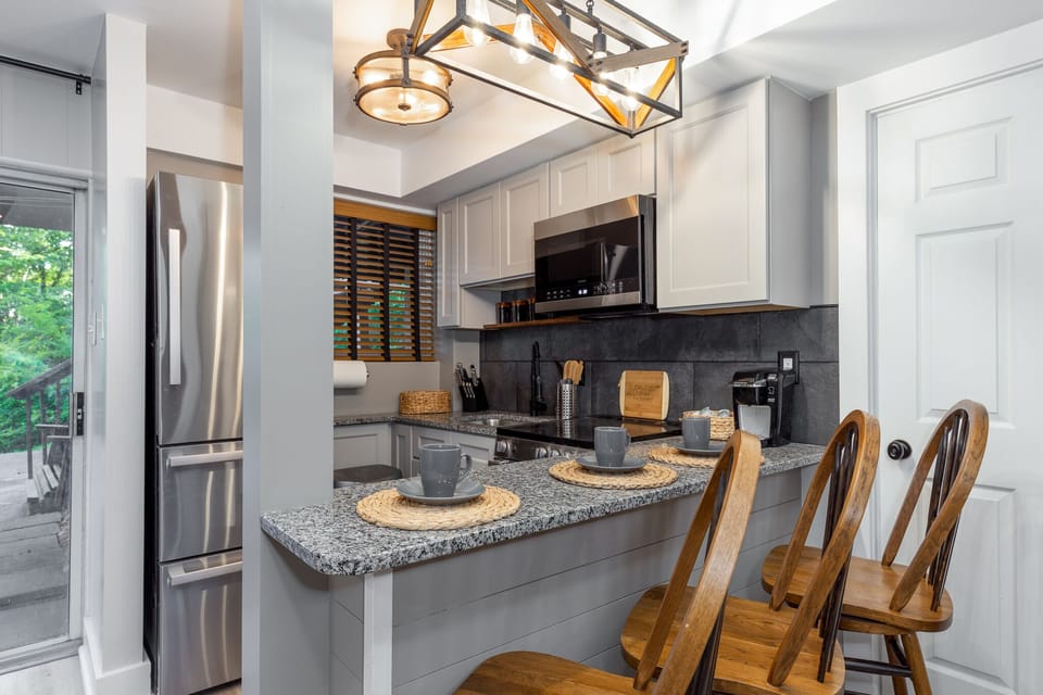 Downstairs kitchen has fridge with ice maker, stove, oven, and microwave 