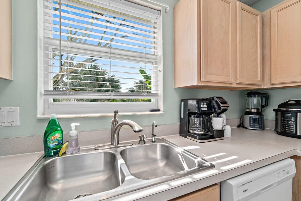 Fully equipped kitchen with flat stove top, refrigerator and freezer, dishwasher, coffee maker and more. (food and coffee not provided)