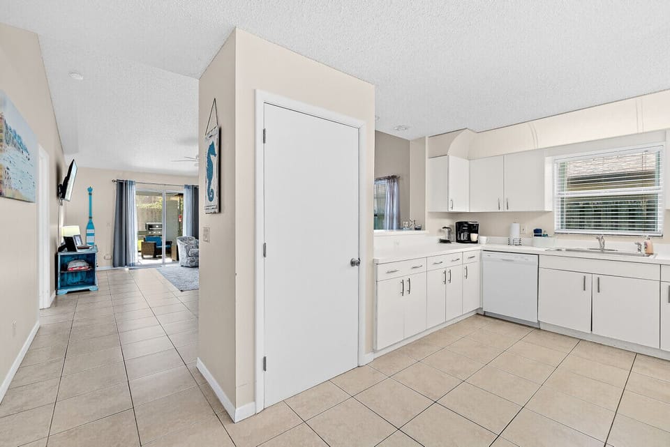 Fully equipped kitchen with flat stove top, refrigerator and freezer, dishwasher, coffee maker and more. (food and coffee not provided)