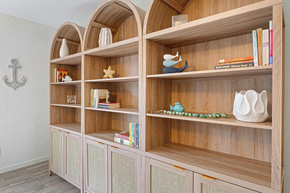 Custom built-in shelving adds warmth and character to the space with plenty of room to tuck away books, games, or personal items during your stay.