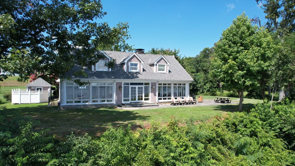 Main House from the water including outdoor patio