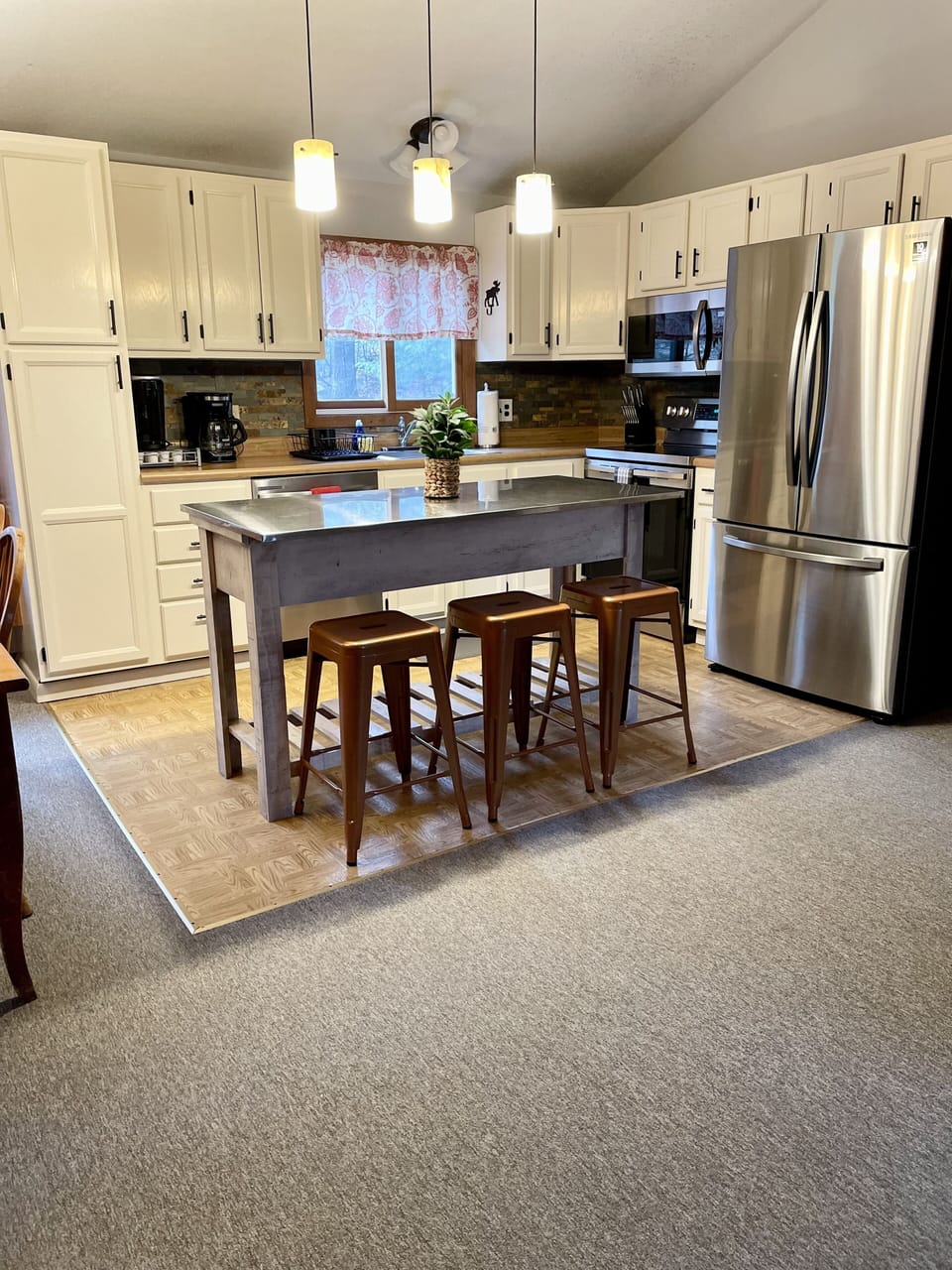 Well stocked kitchen on upper level that opens to dining and living room