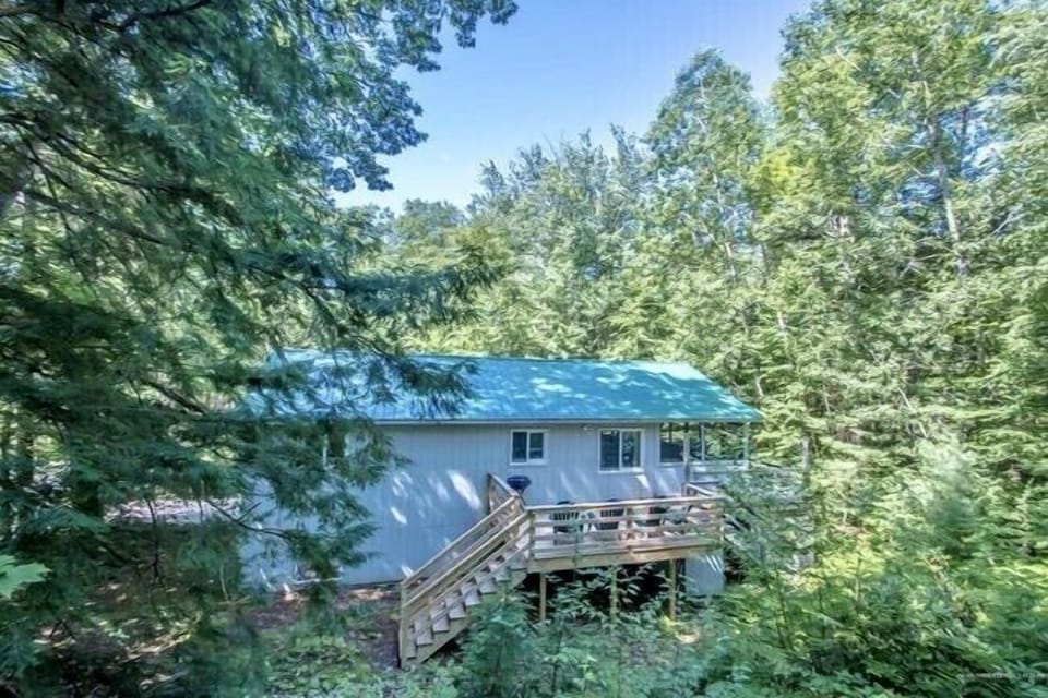 Back of the house surrounded by lovely trees for privacy 
