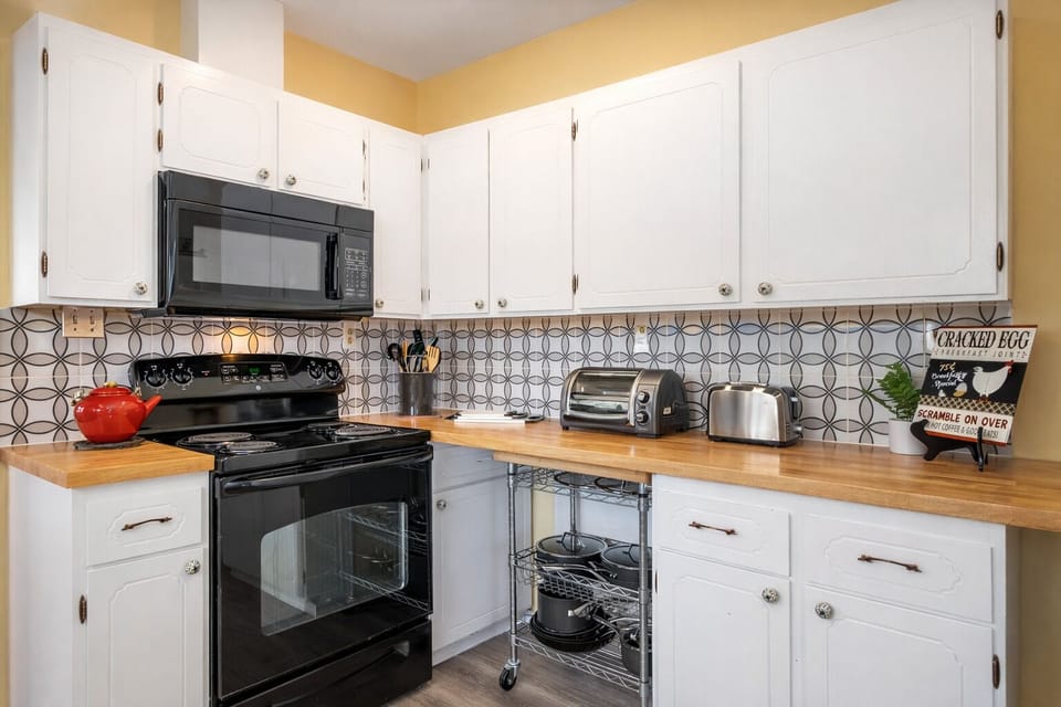 Your fully equipped kitchen features warm wood countertops, sleek appliances, and charming details that make meal prep feel effortless and enjoyable.