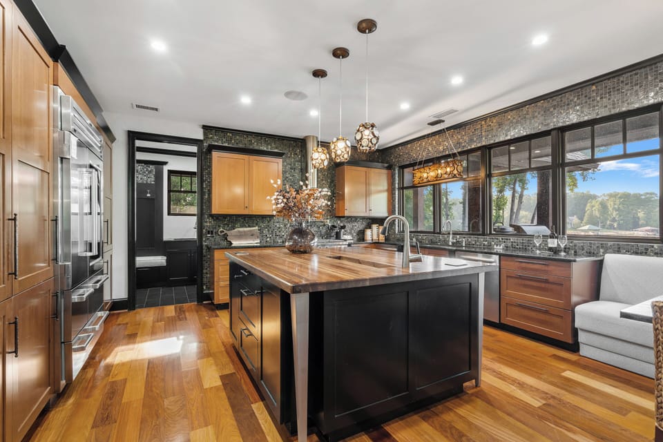 Large kitchen with island, two dishwashers & side by side fridge & freezer.