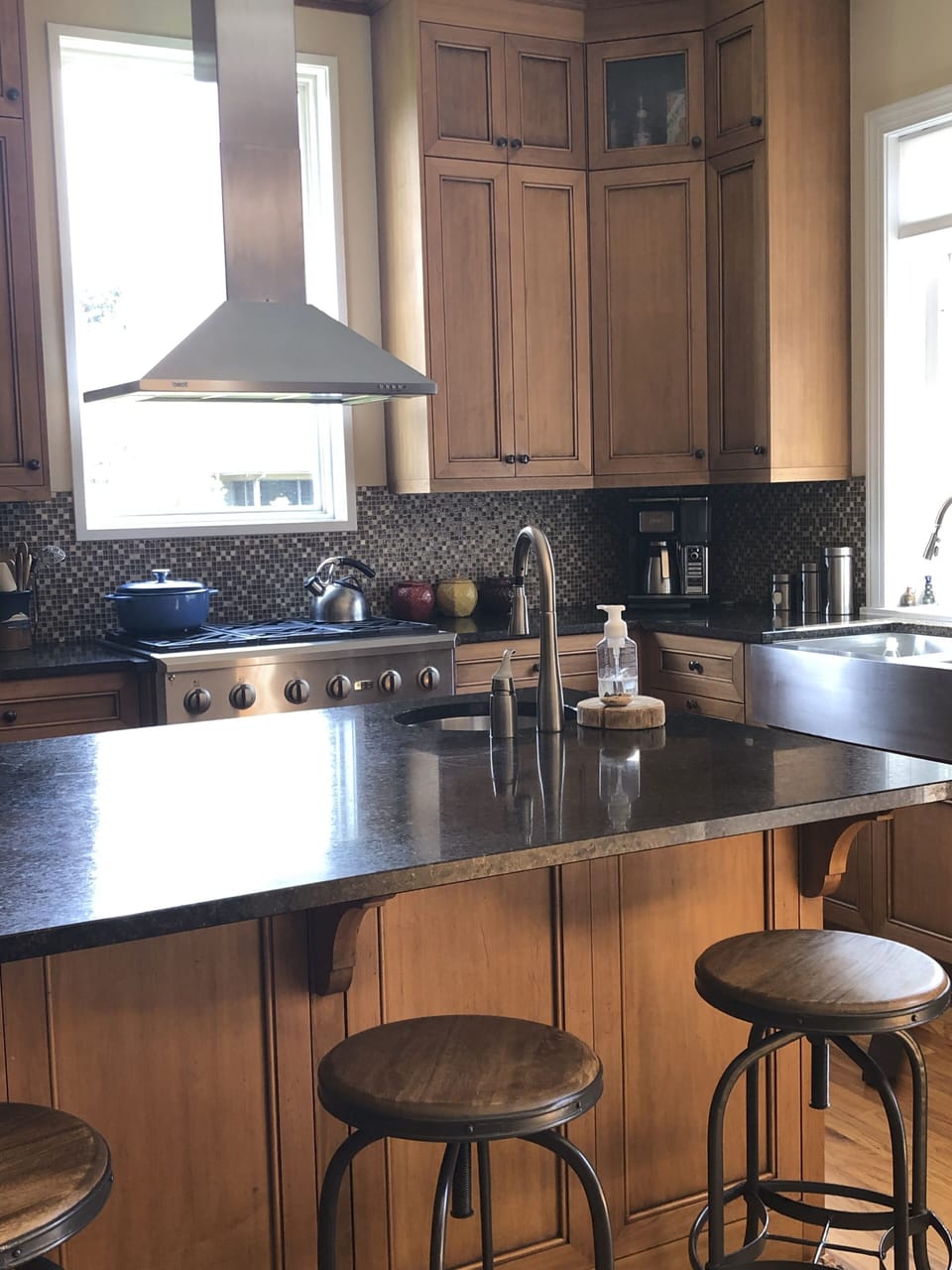 The kitchen is open and has wonderful natural light and a view of the river. 