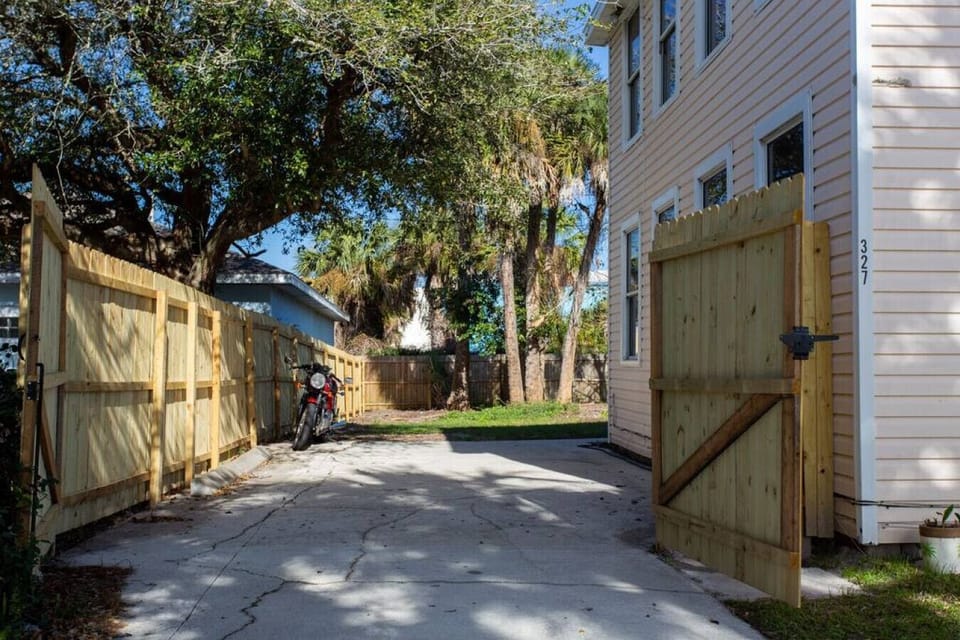 Gated driveway for additional parking. Unfortunately, the motorcycle is not included.