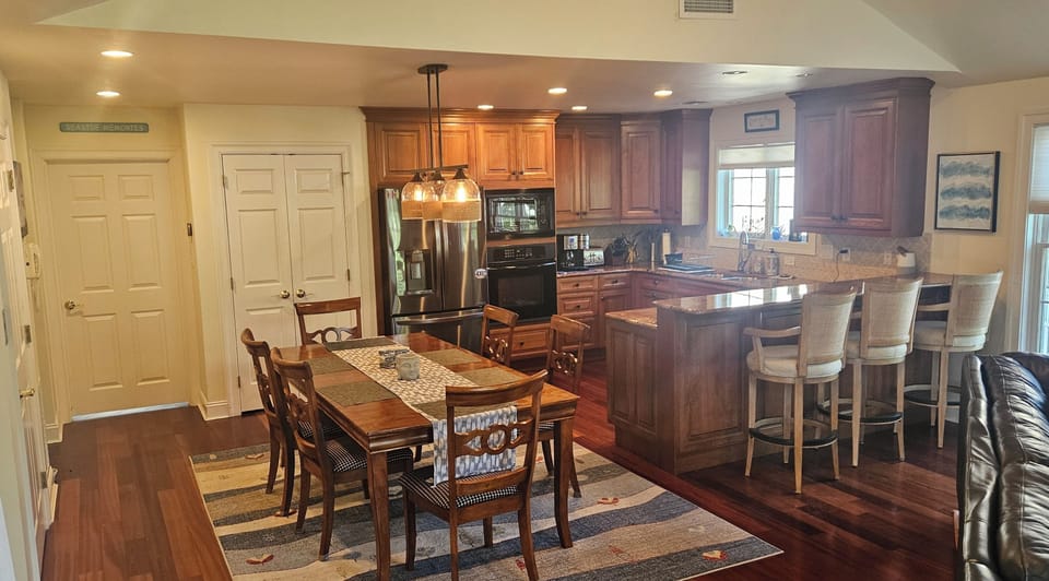 Kitchen with modern appliances, large table seating plus countertop seating