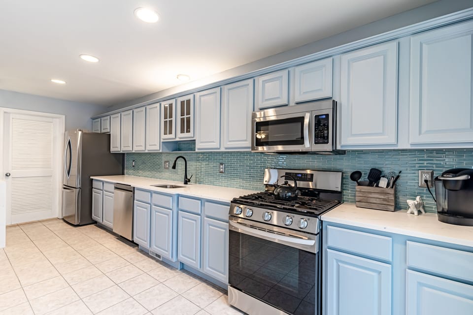 Refrigerator, dishwasher, stove, microwave and Keurig coffee maker in kitchen