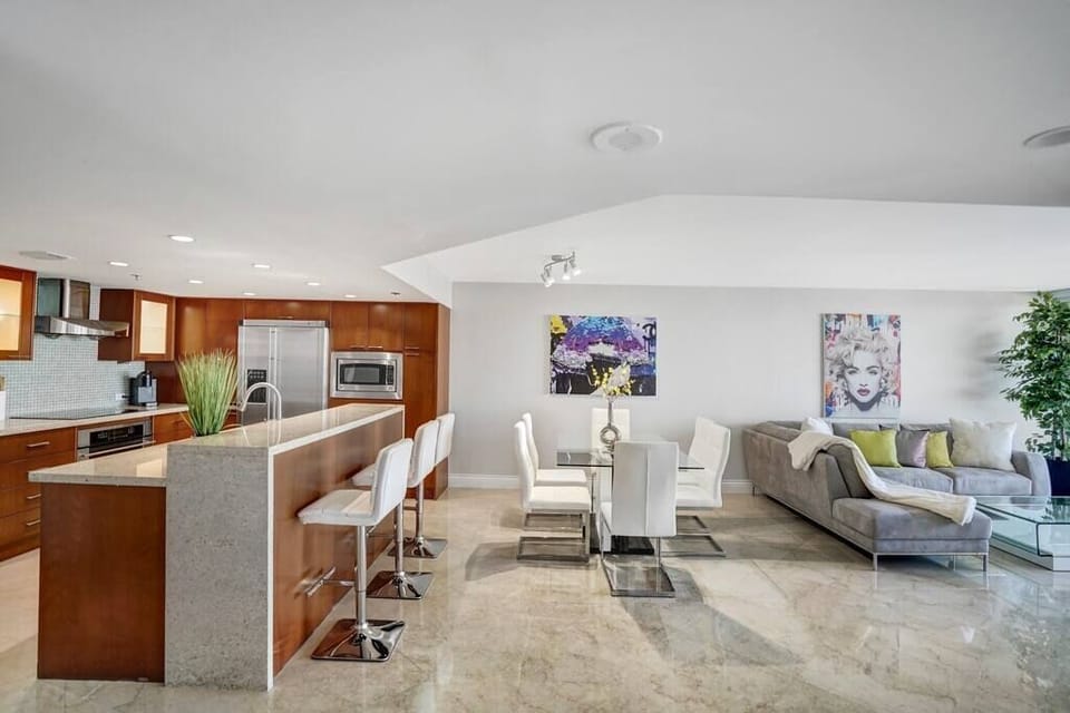 Fully equipped kitchen, dining area, living room with balcony access