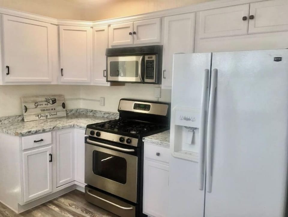 Light and bright friendly kitchen with many cooking utensils.
